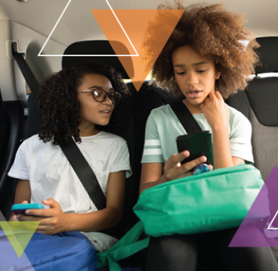 Two young girls sit in the backseat of an MTM Transit vehicle. We are committed to ensuring every trip is important and solving our clients' transit challenges.