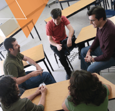 A group of people gather around a classroom to talk about mobility management, travel training, and ADA eligibility/ADA certification.