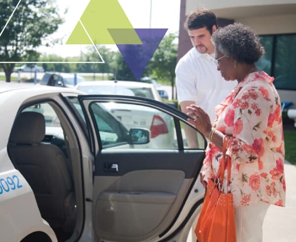 A driver helps a woman into his vehicle. MTM Transit's ADA paratransit brokerage approach leverages the brokerage model to increase the efficiency of paratransit fleets.