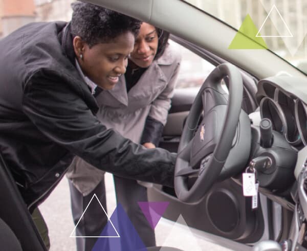 Two women perform an inspection on a vehicle, looking at the steering wheel. To increase the performance of paratransit fleets, MTM Transit utilizes the ADA paratransit brokerage approach and brokerage model.
