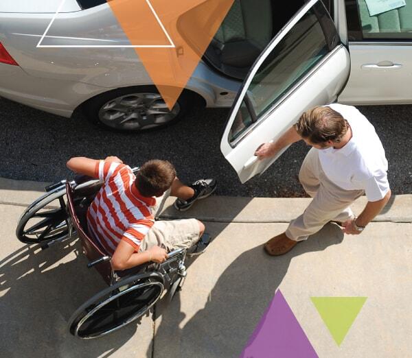 An MTM Transit driver helps a man who utilizes a wheelchair in to his vehicle. While solving our clients' transit challenges, we ensure every trip is important.